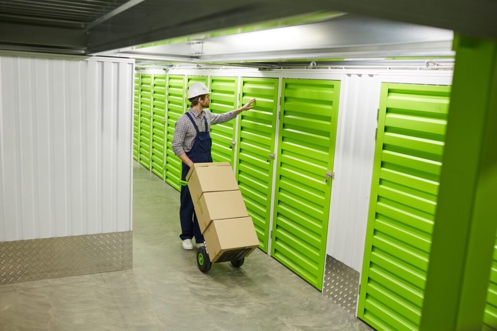 Worker with load in storage room