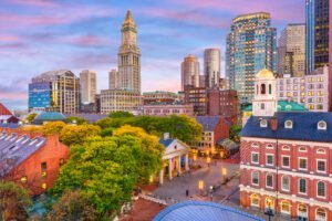 Colorful view of Faneuil Hall and Quincy Market in Back Bay Boston, surrounded by modern skyscrapers.