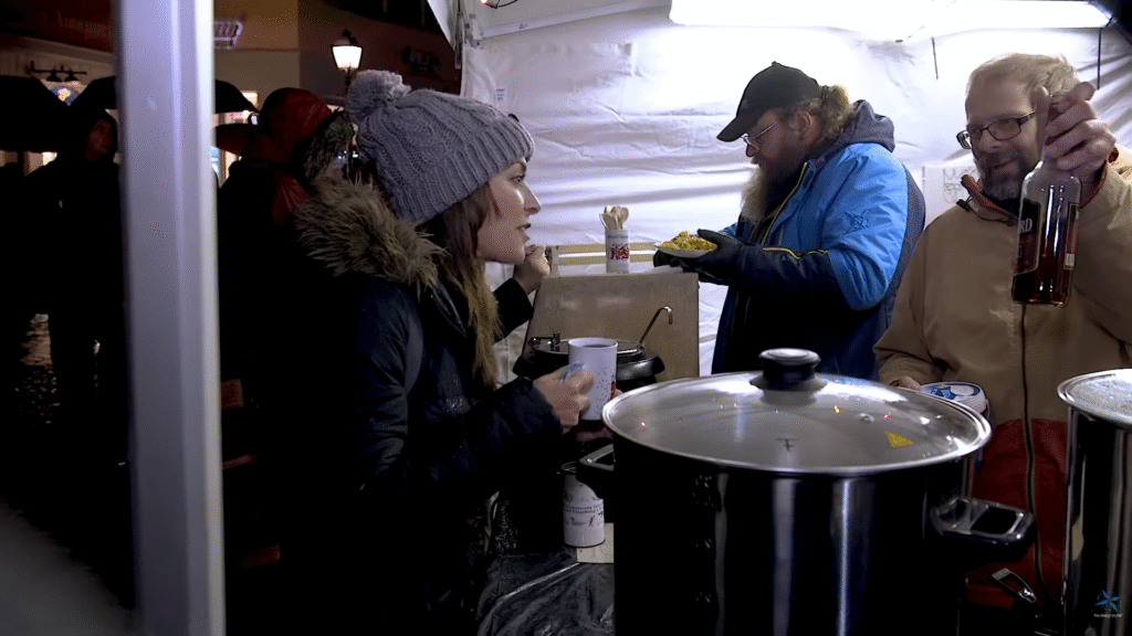 Karen enjoys a warm German spiced drink at a Christmas market stall.