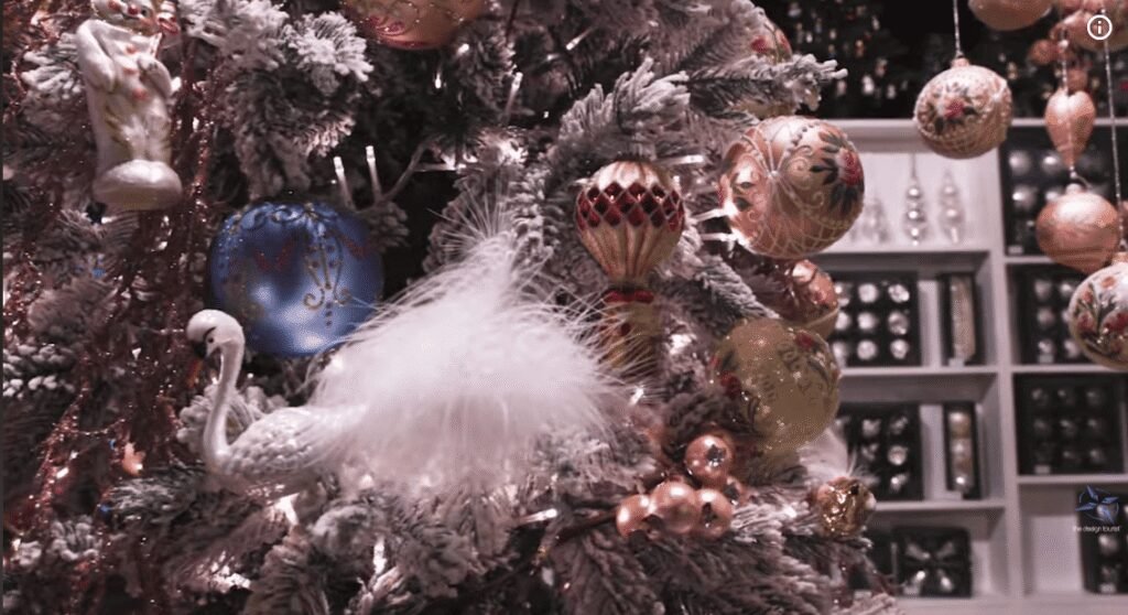 Intricately designed glass Christmas ornaments displayed on a decorated tree in Lauscha.