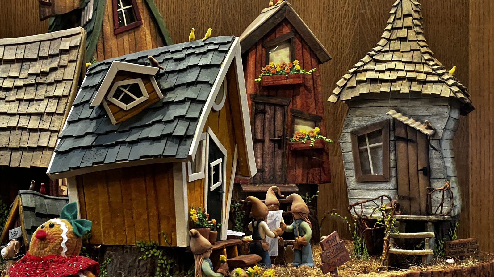 Detailed gingerbread village with miniature houses and figures at the National Gingerbread House Competition inside the Omni Grove Park Inn & Spa.