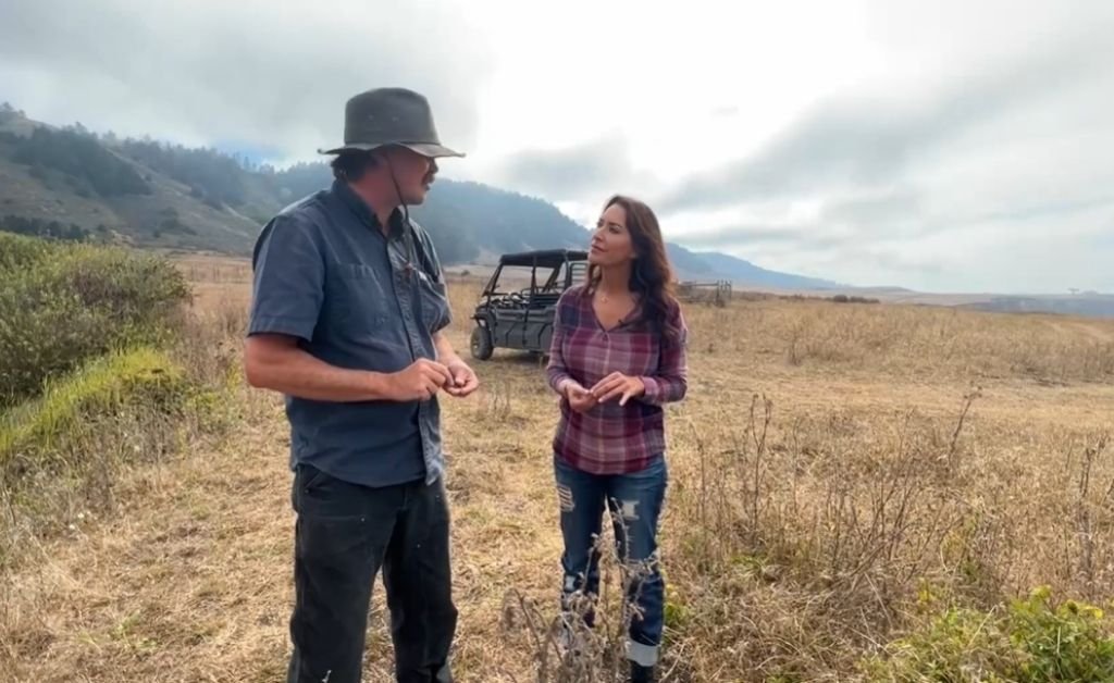 Karen LeBlanc and Otis standing on the bluff at The Inn at Newport Ranch as he shares the history of the Yuki Indians and the former logging town of Newport