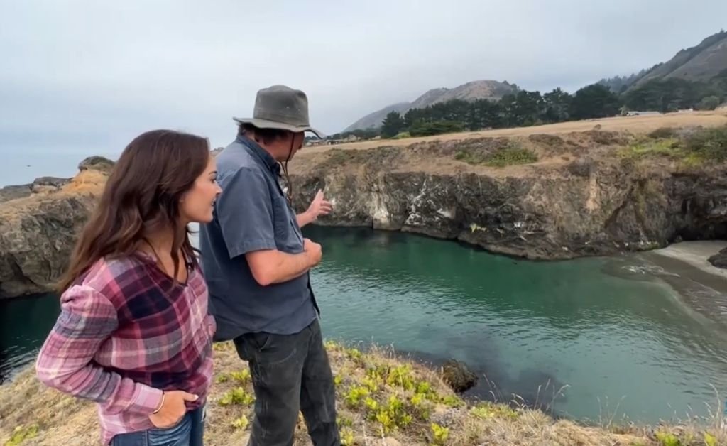 Karen LeBlanc and Otis standing above Secret Beach as Otis describes the cove’s marine life, sea caves and future plans for guest access.