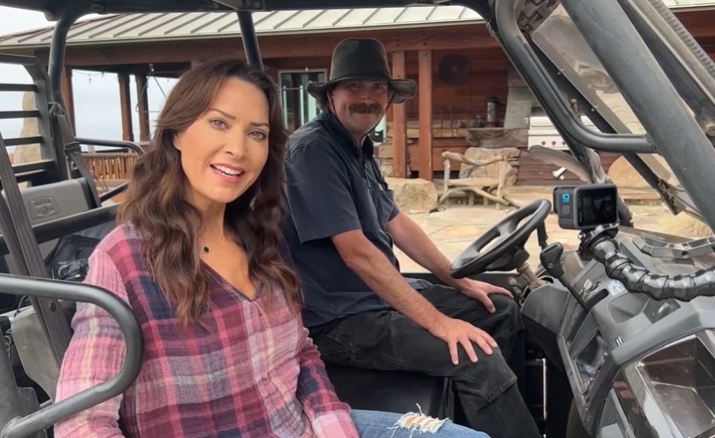 Karen LeBlanc and local guide Otis sitting in a UTV at The Inn at Newport Ranch before beginning the property tour.