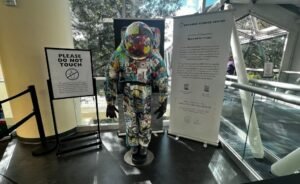 BEYOND Art Spacesuit displayed at Orlando Science Center, covered in hundreds of artworks created by children from around the world.