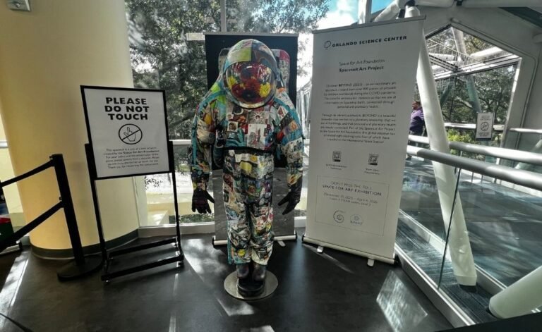 BEYOND Art Spacesuit displayed at Orlando Science Center, covered in hundreds of artworks created by children from around the world.