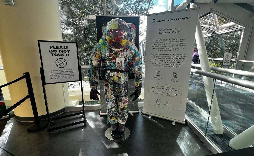 BEYOND Art Spacesuit displayed at Orlando Science Center, covered in hundreds of artworks created by children from around the world.