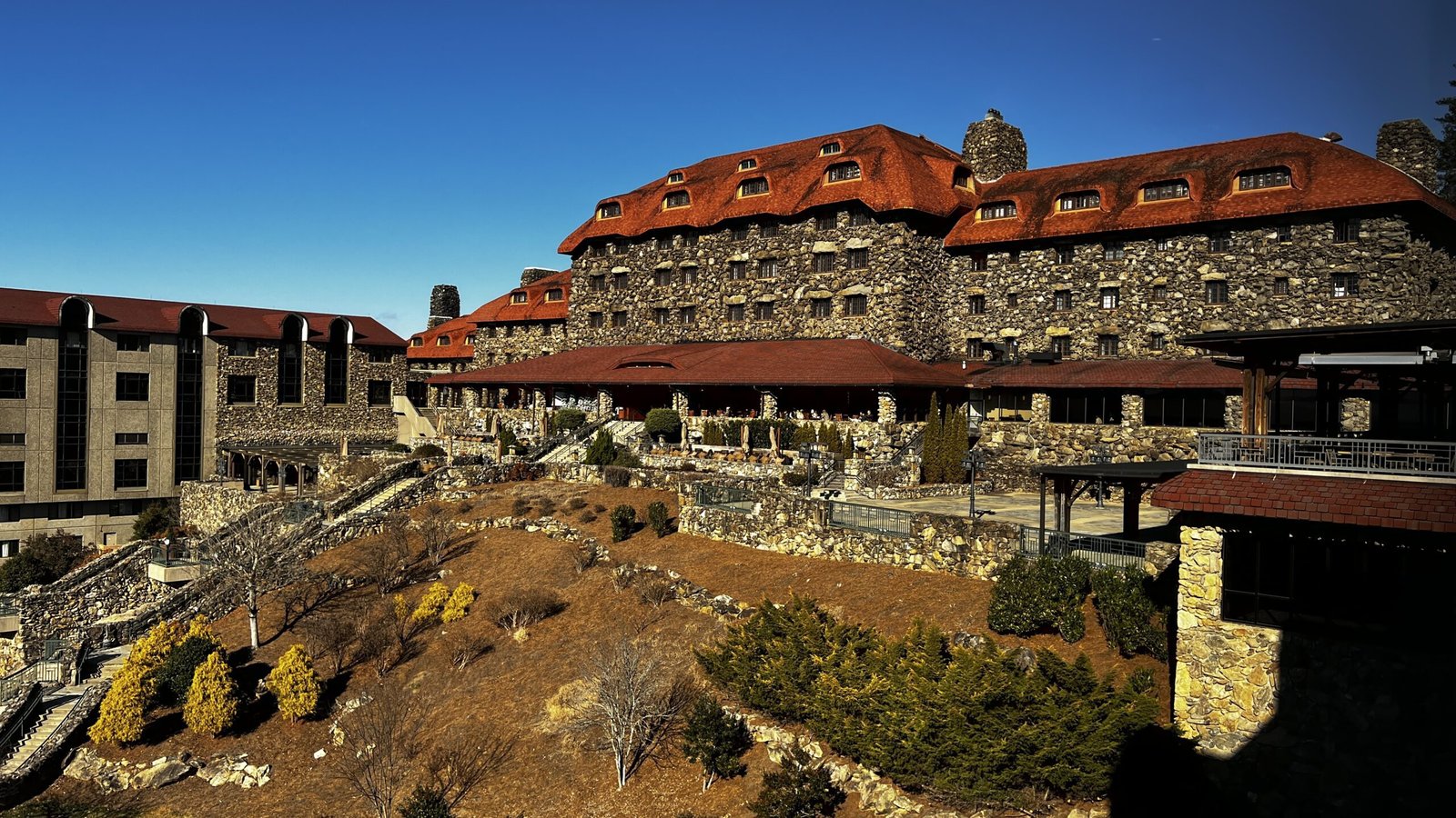Exterior view of the Omni Grove Park Inn & Spa, a historic stone resort overlooking the Blue Ridge Mountains in Asheville, North Carolina.