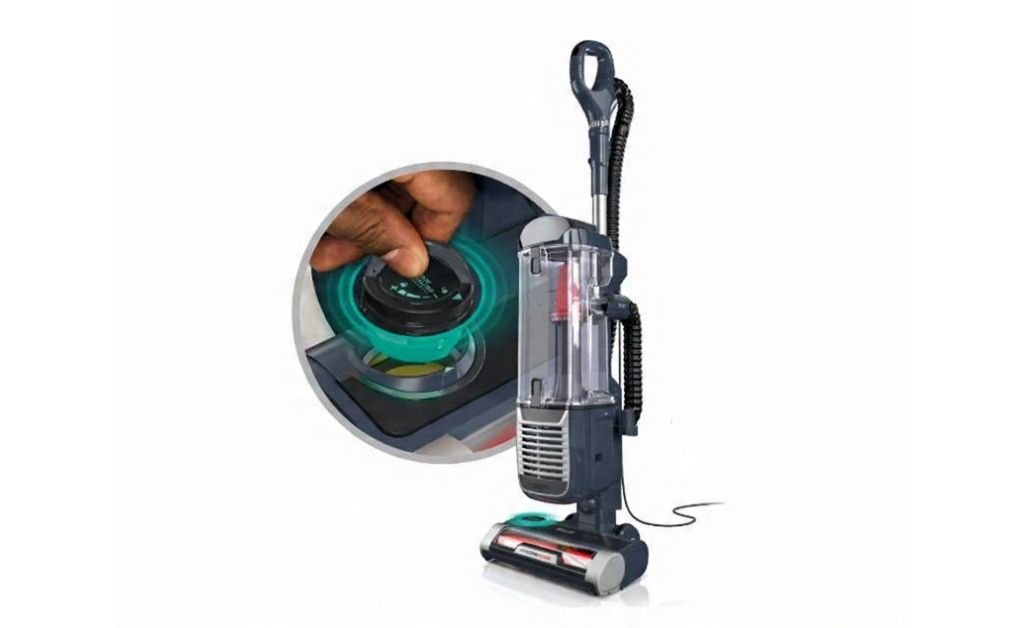 Upright vacuum cleaner with clear dust canister and close-up detail of filter control