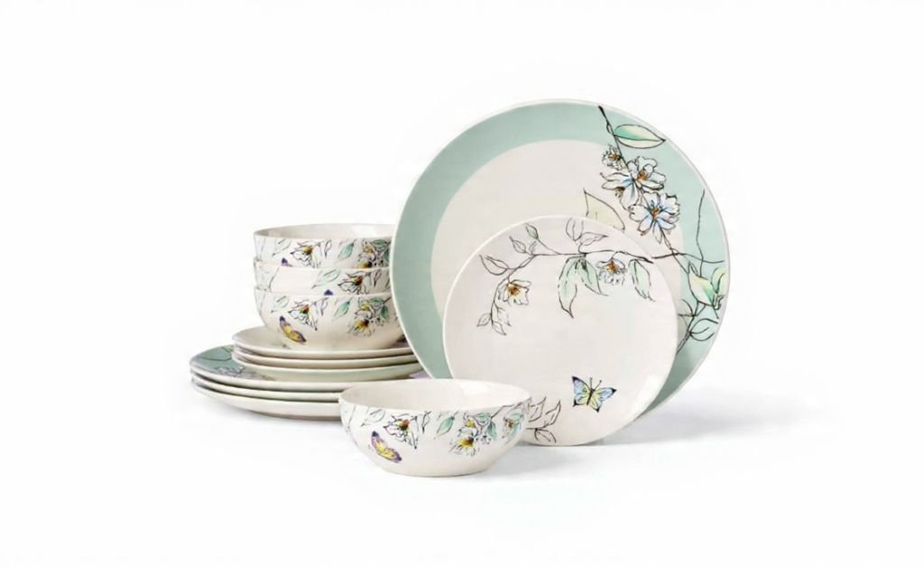 Botanical-patterned dinnerware set with plates and bowls in soft green and cream tones