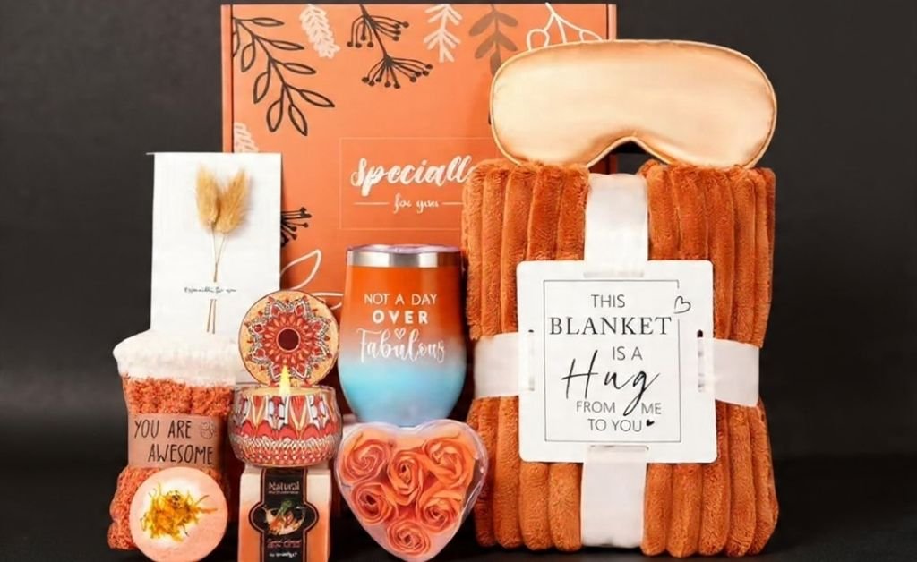 Fall self-care gift basket with blanket, candle, mug, and spa items