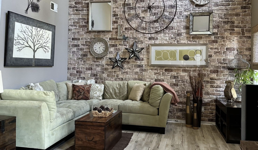 Industrial living room featuring brick accent wall and gallery decor