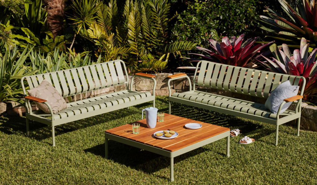 Sage green metal outdoor benches with wooden coffee table
