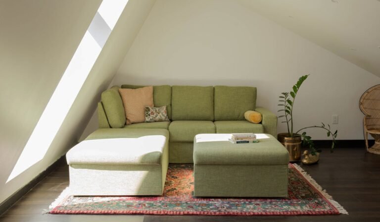 Green sectional sofa in a bright attic with rug