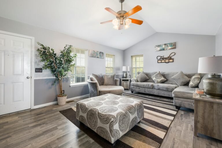 Modern grey living room with sectional sofa and vaulted ceiling