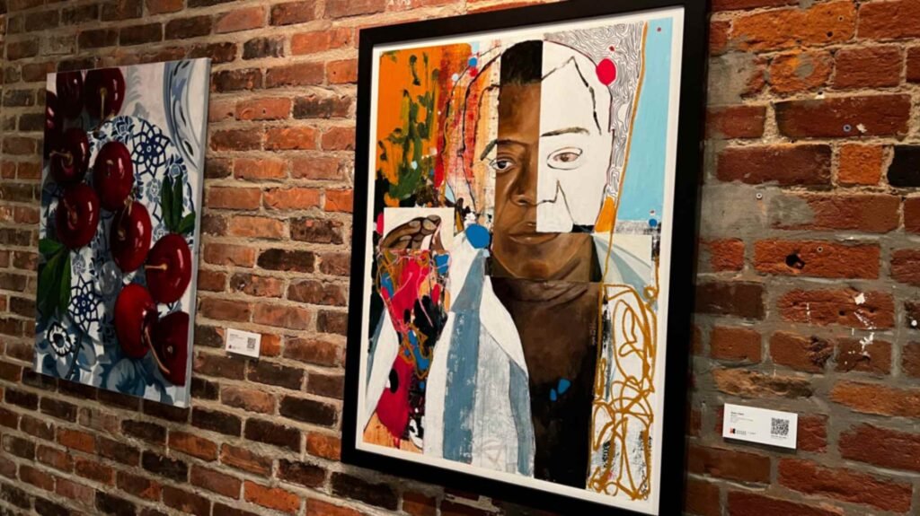 Two framed contemporary paintings hang on an original exposed red brick wall inside a guest room at The Old No. 77 Hotel & Chandlery in New Orleans.